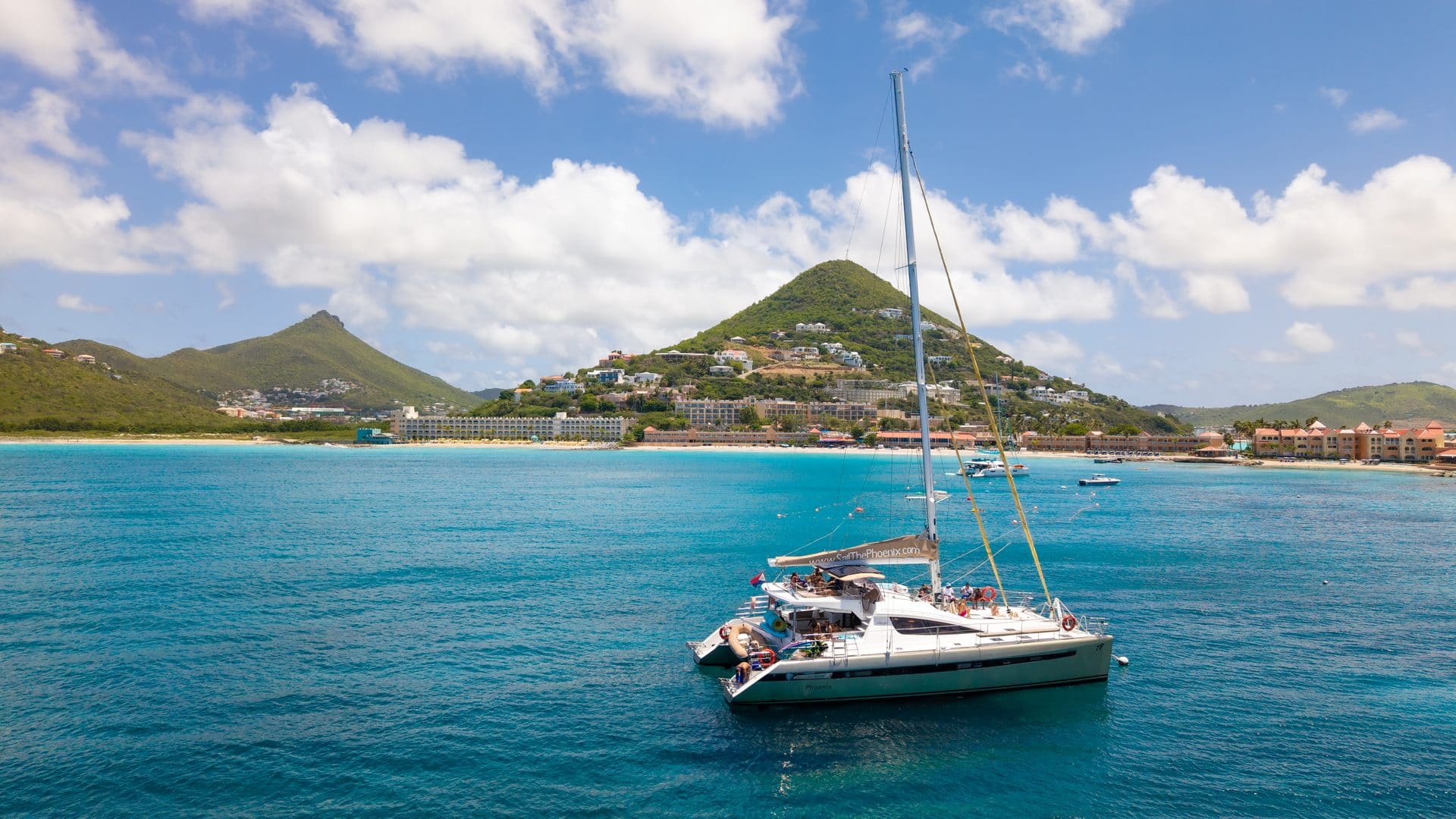 The Phoenix catamaran sailing along the St. Maarten coastline